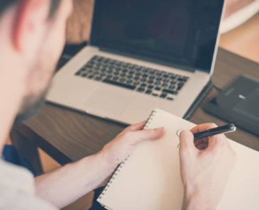 handsome hipster modern man designer working home using laptop at home