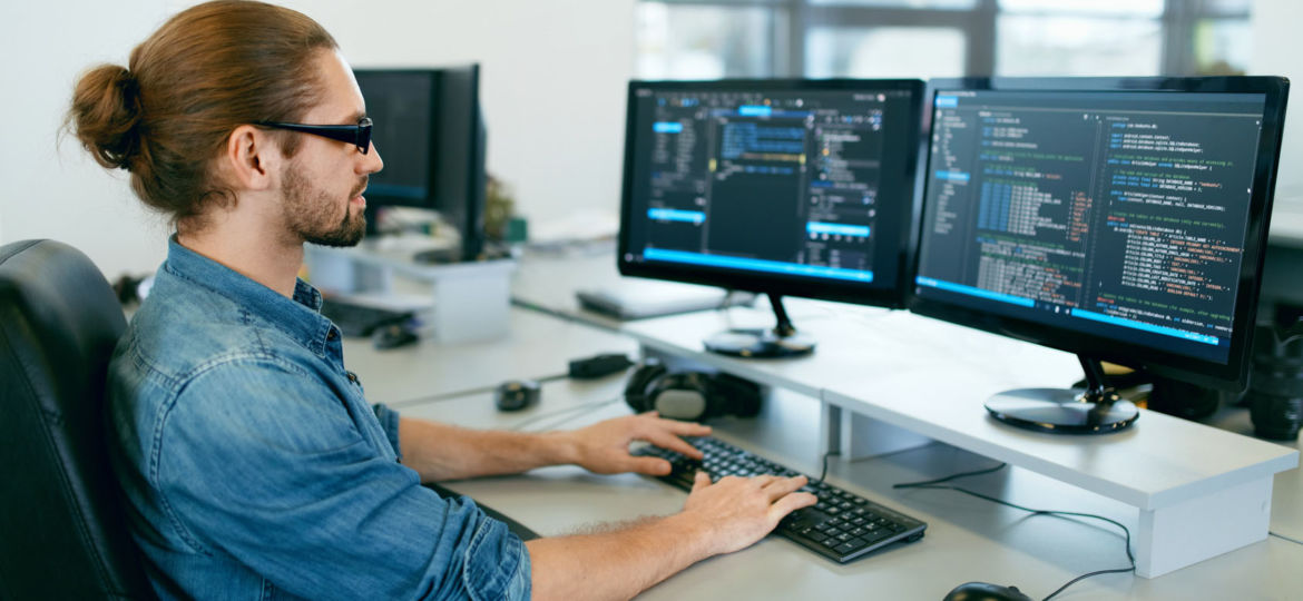 Programming. Man Working On Computer In IT Office